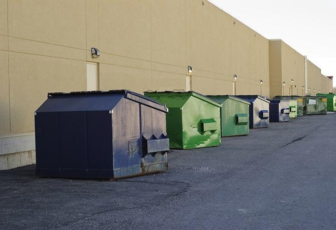 a row of construction dumpsters parked on a jobsite in Jackson